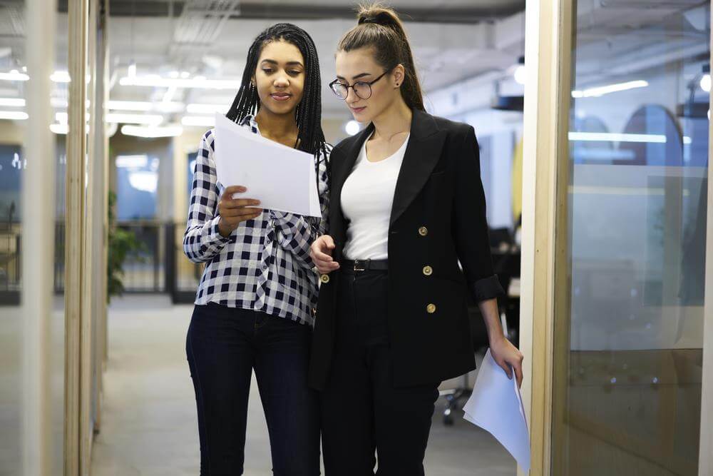 Business woman standing with her staff.